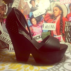 Black open toed platform heel, with ankle strap.